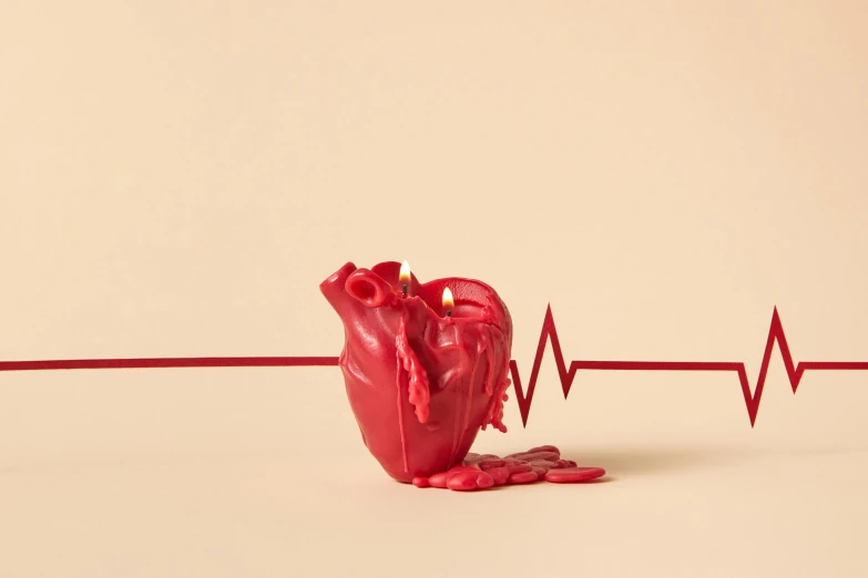 a red heart shaped candle sitting on top of a table, an album cover, hyperrealism, ventricles and aorta, made of glowing wax and ceramic, profile image, press shot