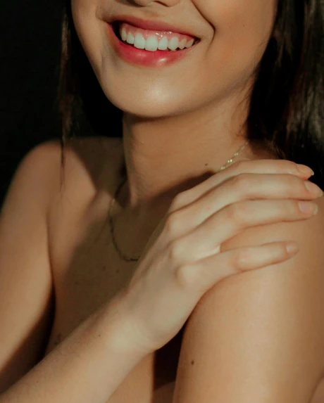 a beautiful young woman posing for a picture, a colorized photo, by Olivia Peguero, trending on pexels, hurufiyya, decolletage, smiling softly, skin made of led point lights, with arms bare