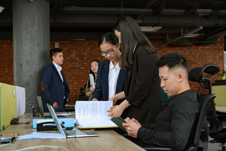 a group of people standing around a wooden table, on a desk, profile image, quy ho, document photo