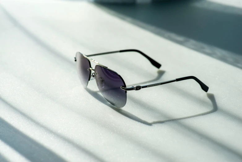 a pair of sunglasses sitting on top of a table, black white purple, thumbnail, chrome hearts, stainless steal