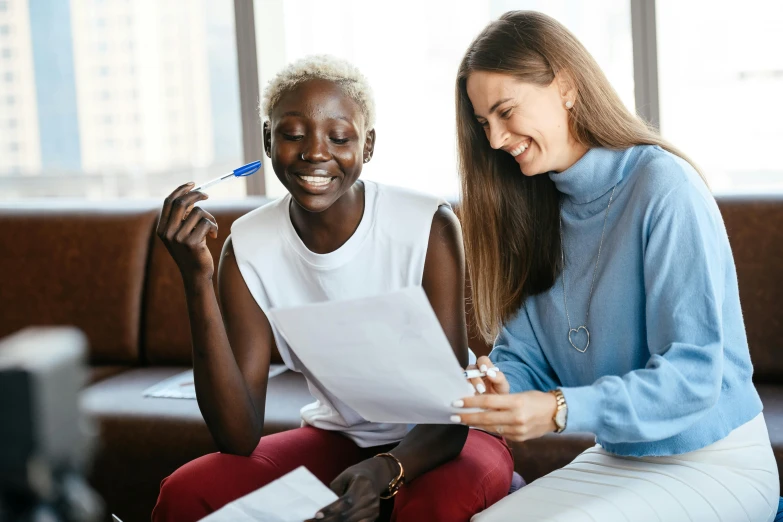 a couple of women sitting on top of a couch, pexels contest winner, hurufiyya, signing a bill, adut akech, 15081959 21121991 01012000 4k, sydney hanson