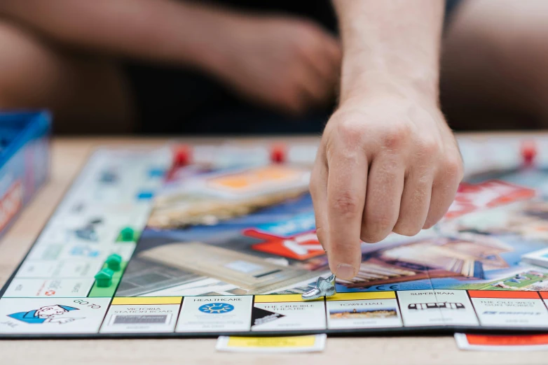 a close up of a person playing a board game, by Daniel Lieske, unsplash, colour print, hyper realistic ”, realistic image, hyperrealistic”