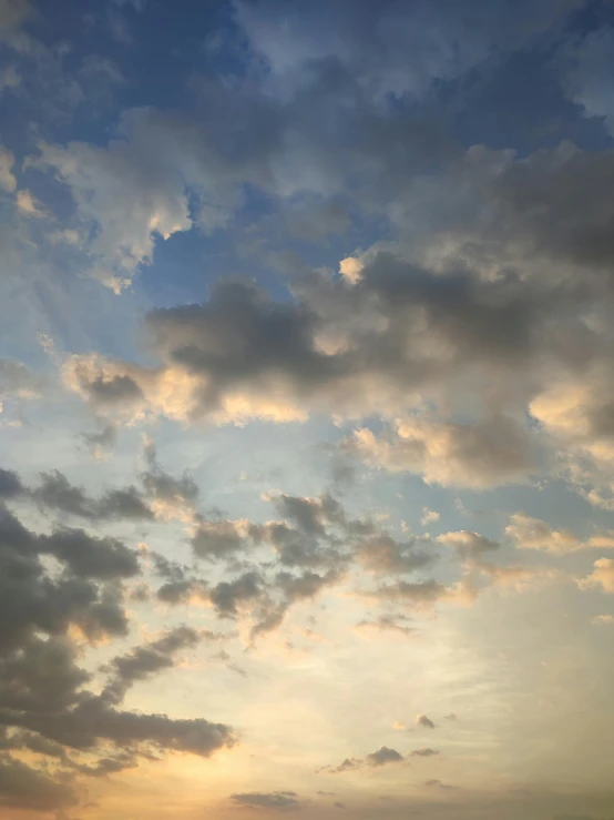 a group of people standing on top of a beach under a cloudy sky, a picture, unsplash, romanticism, aesthetic clouds in the sky, ☁🌪🌙👩🏾, patches of yellow sky, sky made of ceiling panels