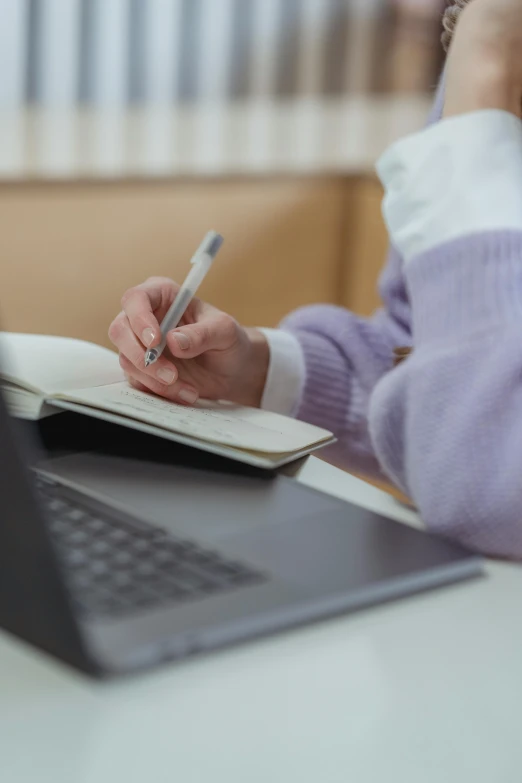 a woman sitting at a table with a laptop and a pen, a digital rendering, pexels, craigslist photo, lined paper, academic, thumbnail