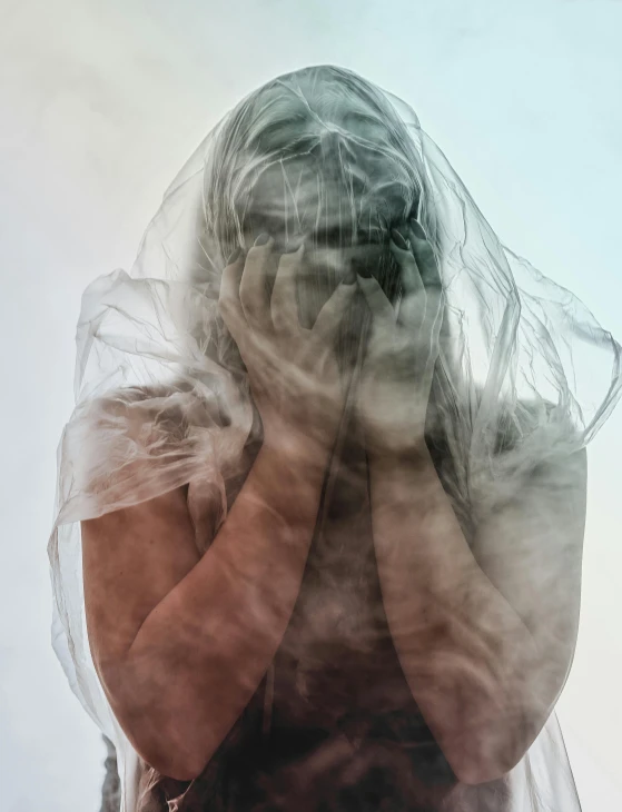 a woman with a veil covering her face, transgressive art, in a cloud, translucent body, photograph taken in 2 0 2 0, trending photo