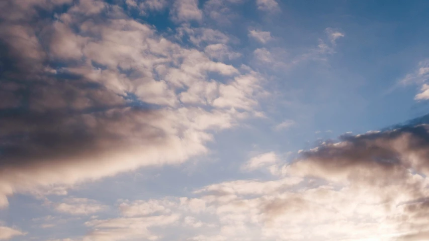 a person flying a kite on a cloudy day, unsplash, minimalism, layered stratocumulus clouds, evening sunlight, low angle 8k hd nature photo, “puffy cloudscape