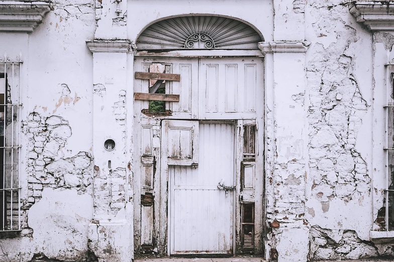 an old building with peeling paint and a door, by Lucia Peka, visual art, white, background image, colonial, instagram photo