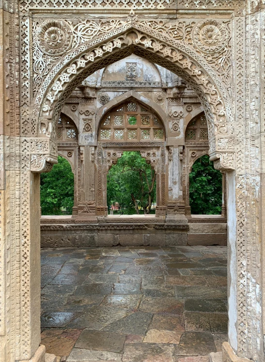 a close up of an archway with a building in the background, inspired by Steve McCurry, arabesque, reza afshar, beautiful ancient garden behind, intricate ”, award - winning photo ”