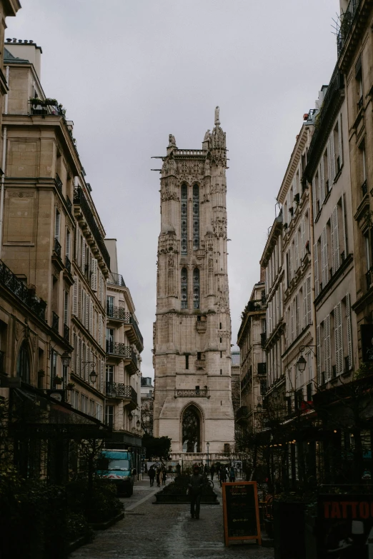 a very tall clock tower towering over a city street, by Raphaël Collin, pexels contest winner, baroque, gothic revival, ivory, square, exterior photo