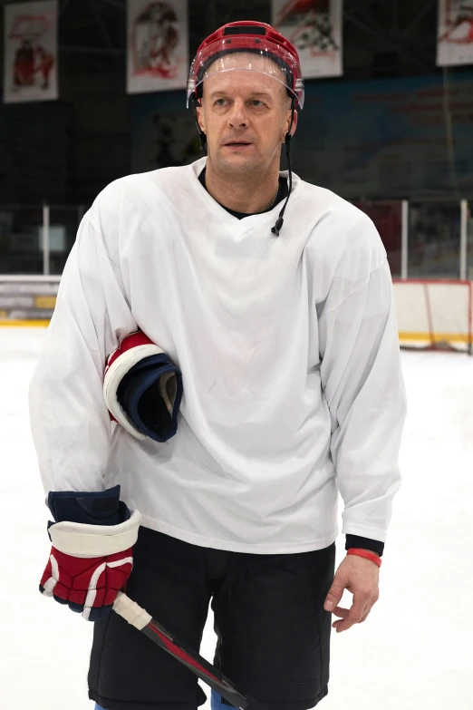 a man standing on the ice with a hockey stick, a portrait, shutterstock, wearing a white sweater, nathan fillion, no - text no - logo, game ready