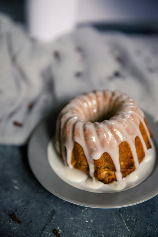 a bundt cake sitting on top of a white plate, a still life, unsplash, kek, icy, alabama, square