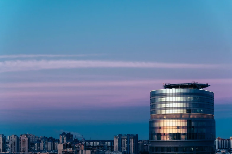 a very tall building sitting in the middle of a city, pexels contest winner, bauhaus, twilight ; wide shot, azamat khairov, rounded architecture, high resolution print :1 cmyk :1