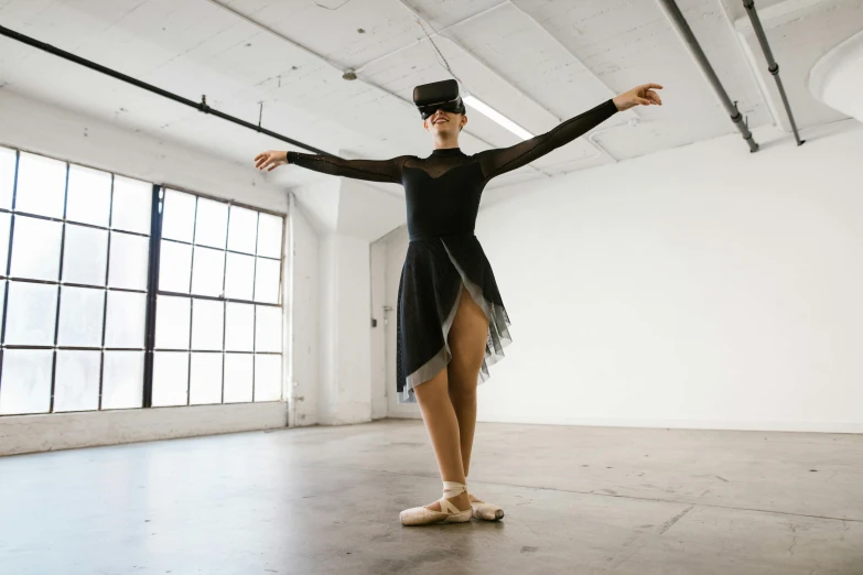 a woman that is standing in a room, a hologram, inspired by Elizabeth Polunin, unsplash, arabesque, wearing black old dress and hat, wearing vr goggles, dressed as a ballerina, lachlan bailey