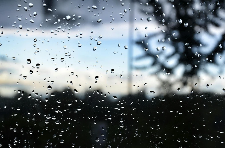 a close up of a window with raindrops on it, by Ryan Pancoast, hurufiyya, background image, afternoon, calm weather, pouring