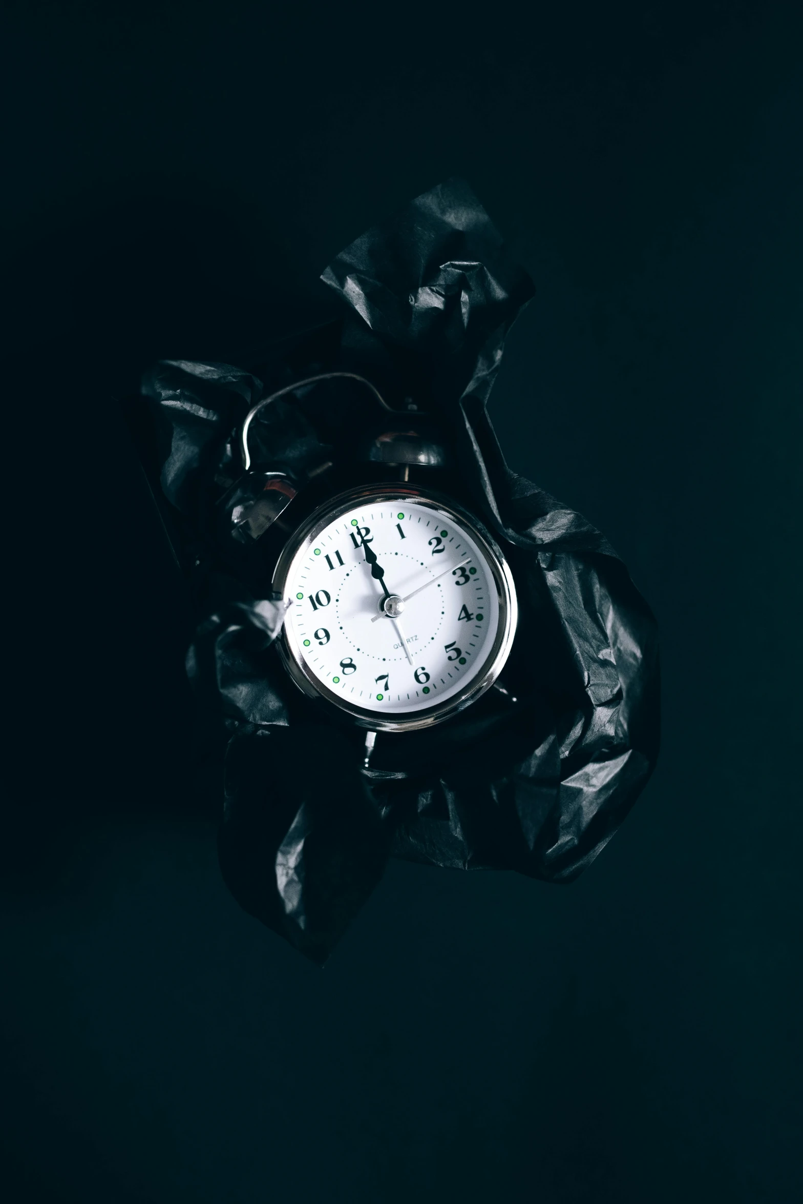 a clock sitting on top of a leaf covered table, an album cover, unsplash, happening, pitch black background, ripping the fabric of spacetime, pocket watch, beaten