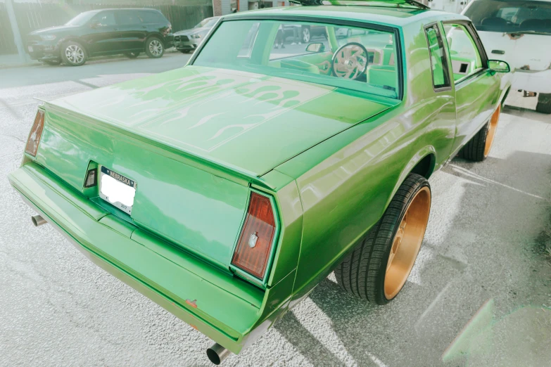 a green car parked in a parking lot, an album cover, by Drew Tucker, pexels contest winner, hyperrealism, lowriders, largest haunches ever, gold body, teddy fresh