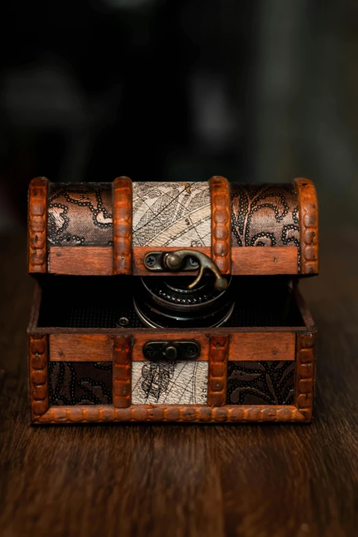 a wooden chest sitting on top of a wooden table, a portrait, by Jessie Algie, unsplash, intricate steampunk ornate, shot with sony alpha 1 camera, high resolution product photo, patterned