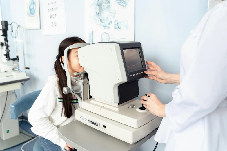 a woman getting her eye examined by a doctor, by Jang Seung-eop, pexels contest winner, hurufiyya, looking at monitor, jaeyeon nam, 90s photo, school class