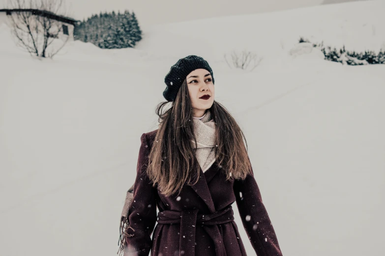 a woman standing in the snow wearing a coat, pexels contest winner, antipodeans, maroon hat, avatar image, girl with brown hair, lorde