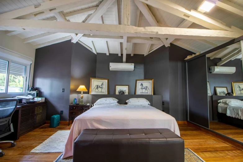 a bed sitting inside of a bedroom on top of a hard wood floor, visual art, vaulted ceiling, charcoal and silver color scheme, madagascar, of augean stables