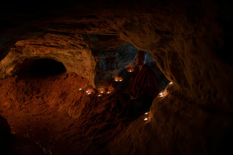 a group of people standing inside of a cave, buddhist monk meditating, alessio albi, profile image, candle lit