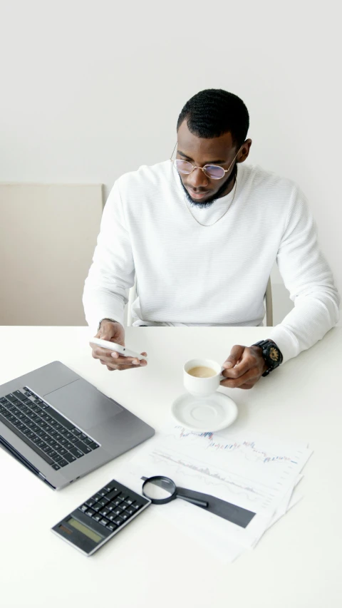 a man sitting at a table with a laptop and a cup of coffee, trending on pexels, afro tech, white backround, square, teaching