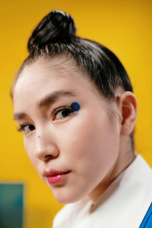 a close up of a person with blue eyes, an album cover, inspired by Yves Klein, trending on pexels, pop art, a young asian woman, primary colors, complimentary eyeliner, set on singaporean aesthetic