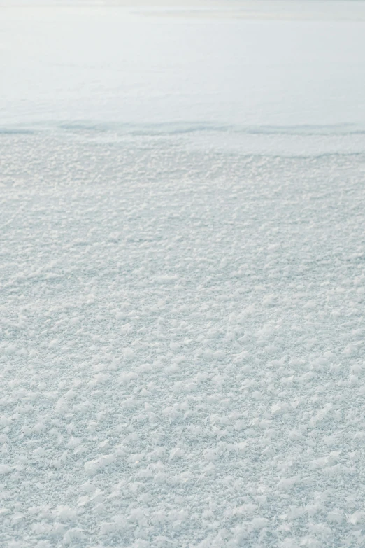 a man riding a snowboard down a snow covered slope, an album cover, inspired by Andreas Gursky, trending on unsplash, crystalized scales, lots of white cotton, textured like a carpet, medium close-up