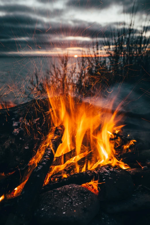 a campfire in the middle of a field, pexels contest winner, romanticism, energy flows of water and fire, up-close, profile pic, uploaded