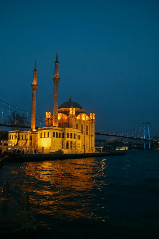 a large building sitting on top of a body of water, inspired by Osman Hamdi Bey, nightlife, mosque, harbour, during night