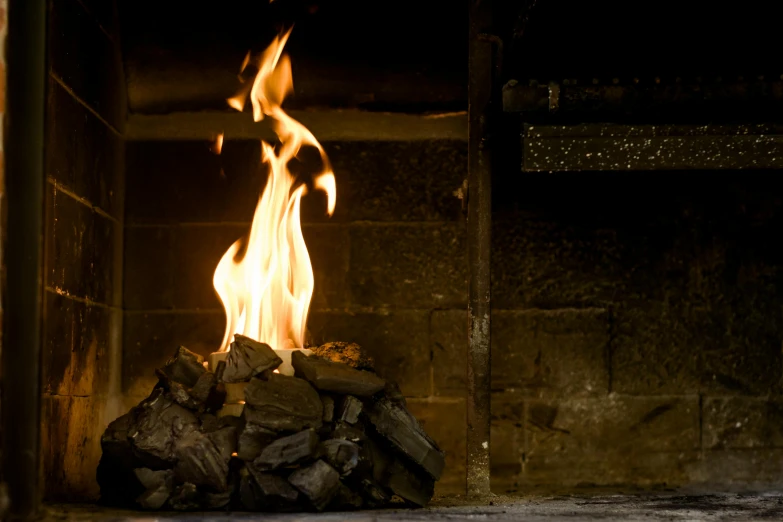 a close up of a fire in a fireplace, by John Murdoch, anthracite, hegre, foreground background, forge