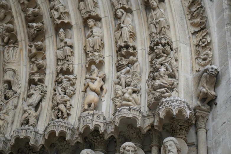 a group of statues on the side of a building, a marble sculpture, by Raphaël Collin, unsplash, romanesque, intricate gothic bones and meat, beige, massive arch, many small details