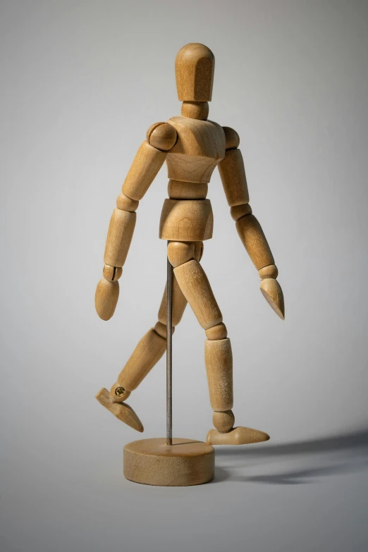 a wooden mannequin standing on a stand, by David Simpson, visual art, art toys on feet, no - text no - logo, dancing, knee