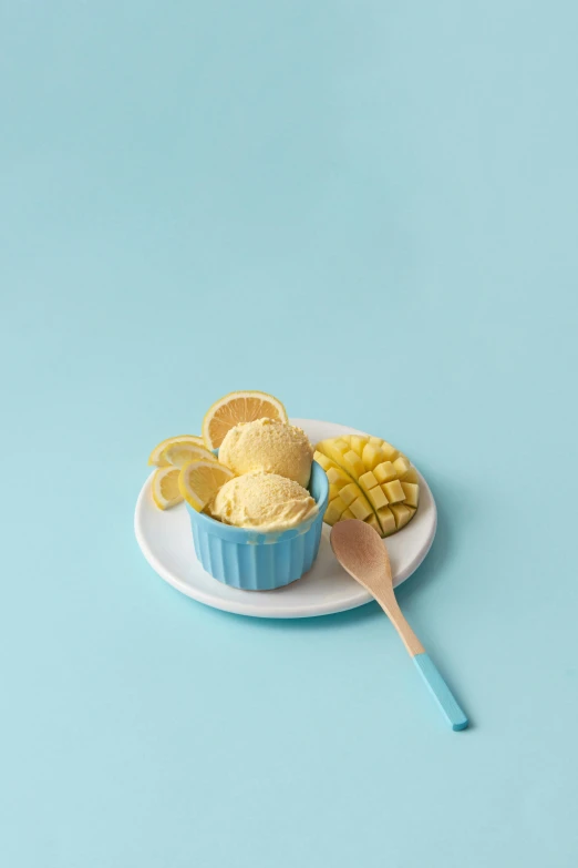 a bowl of ice cream sitting on top of a white plate, blue theme and yellow accents, 2019 trending photo