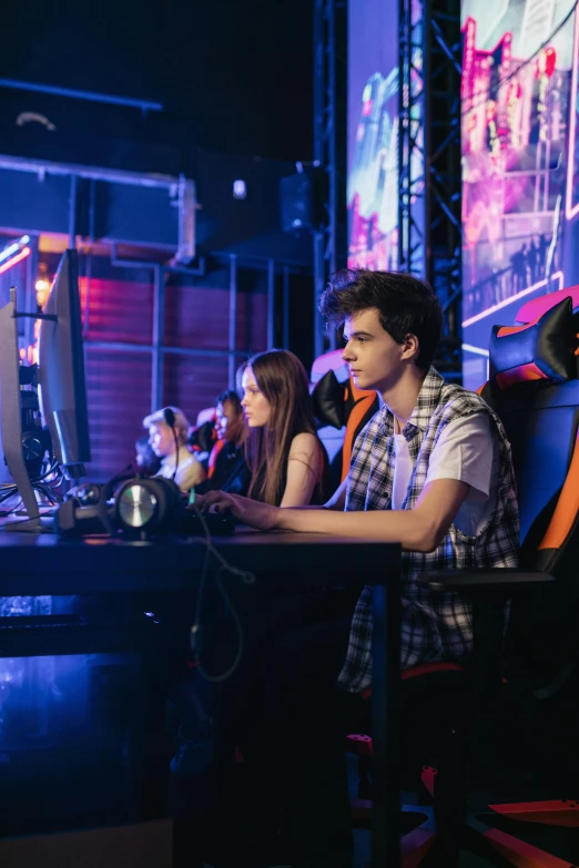 a group of people playing a game on a computer, e-sport style, looking off to the side, promo image, high school