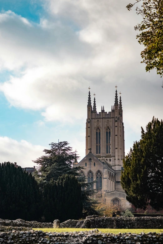 a large church tower towering over a lush green field, inspired by Richmond Barthé, unsplash, renaissance, city buildings on top of trees, bath, silver，ivory, exterior view