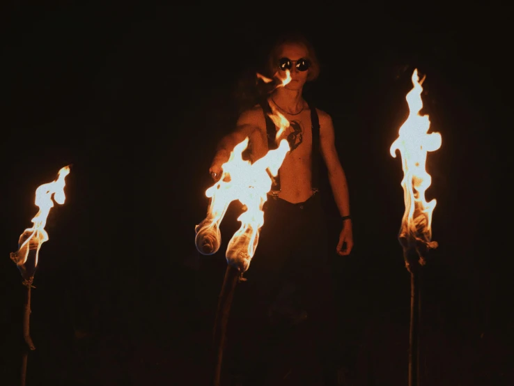 a man standing in front of a bunch of torches, pexels contest winner, renaissance, photograph of three ravers, heilung, circus performance, avatar image