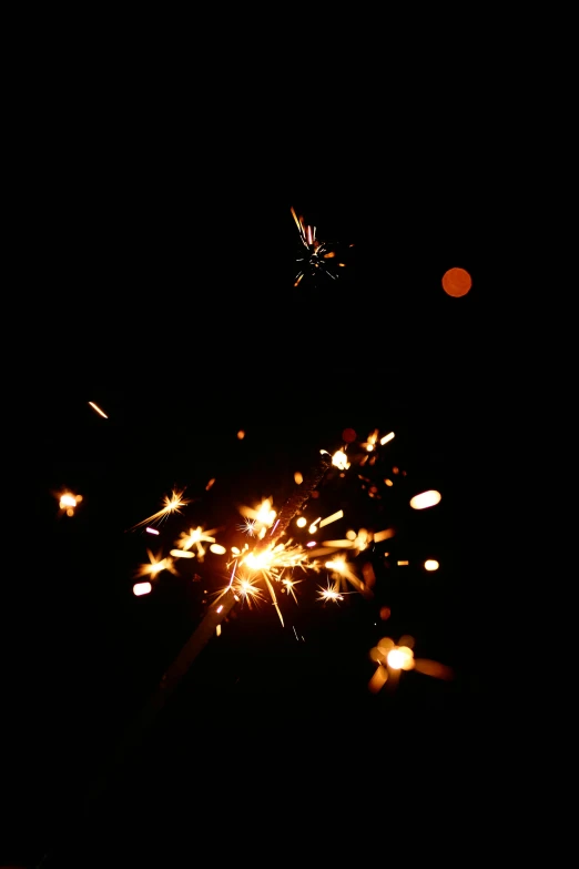 a close up of a sparkler in the dark, pexels, light and space, 1999 photograph, confetti, medium format. soft light, 1 2 9 7