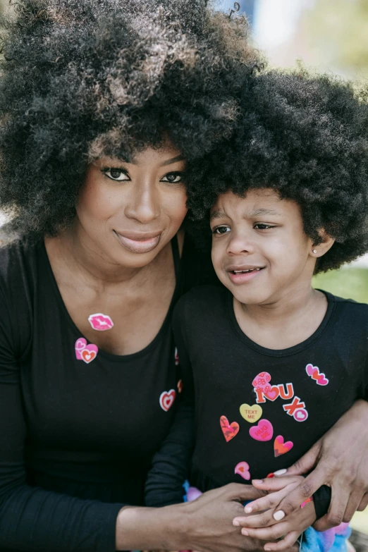 a woman and a child posing for a picture, pexels, funk art, lush unkempt black hair, puffy sticker, with black, womanhood”