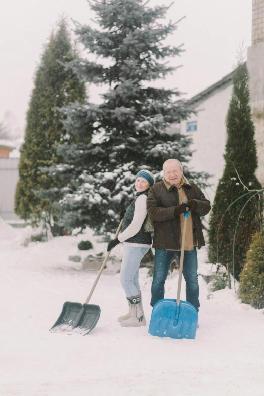 a couple of people that are standing in the snow, in the yard, promo image, big shovel, grandfatherly