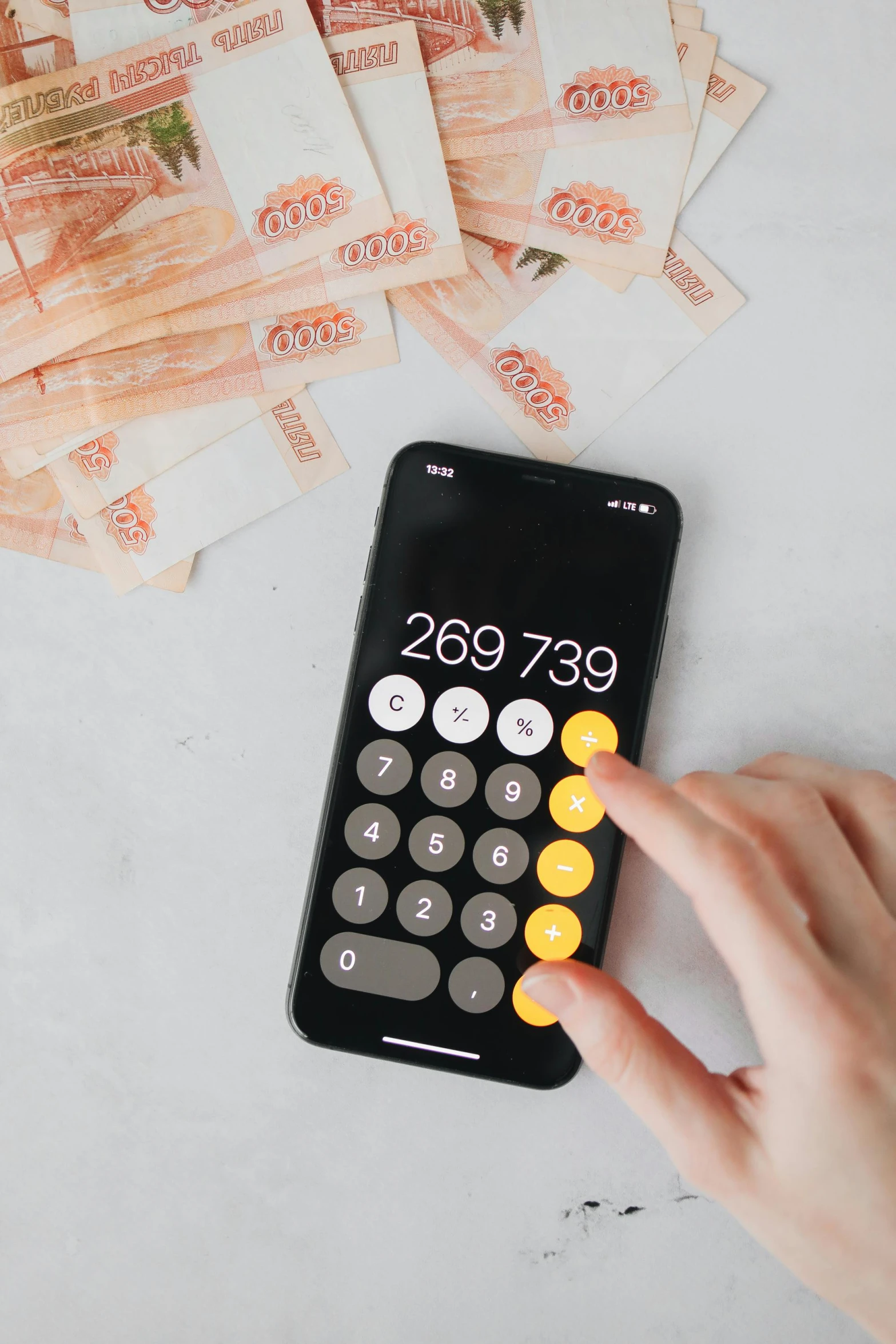 a person holding a calculator next to a pile of money, digital ui, thumbnail, 000 — википедия, square