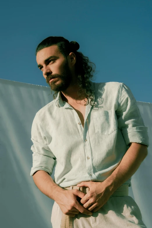 a man standing on top of a tennis court holding a racquet, an album cover, inspired by Camilo Egas, photorealism, shoulder long hair, wearing a white button up shirt, hozier, singer maluma