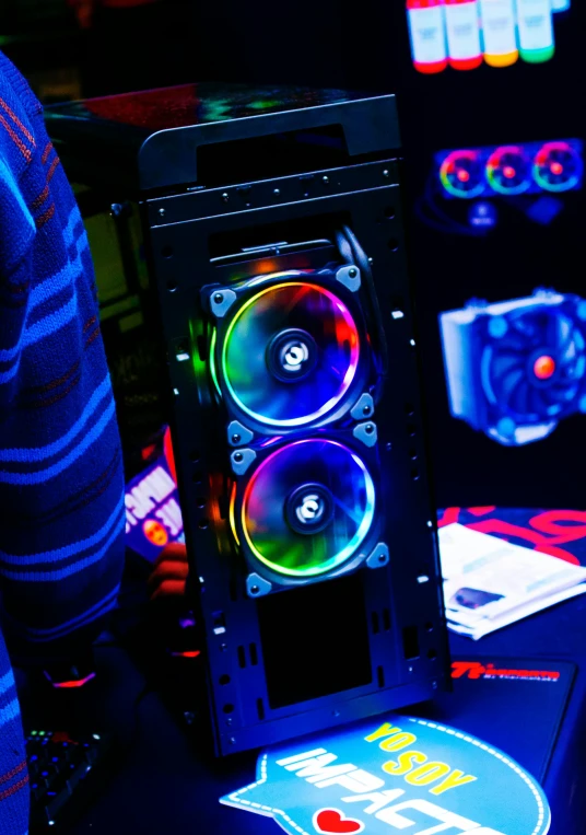 a computer case sitting on top of a table, by Dan Content, colourful lighting, fans, banner, rb6s)