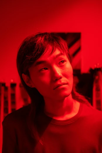 a man standing in front of a red light, inspired by Zhu Da, looking intensely at the camera, hsiao-ron, gongbi, strong studio lights