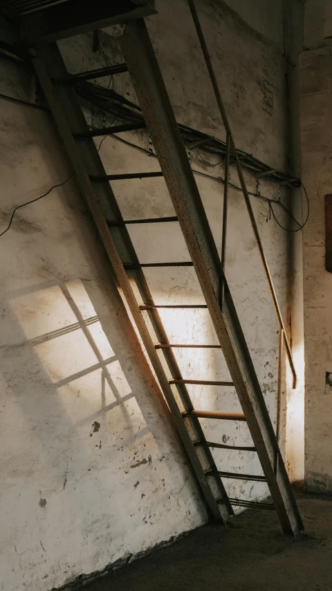 a ladder leaning against a wall in a room, inspired by Elsa Bleda, pexels, sun lighting from above, exposed wires, silo, shaded lighting