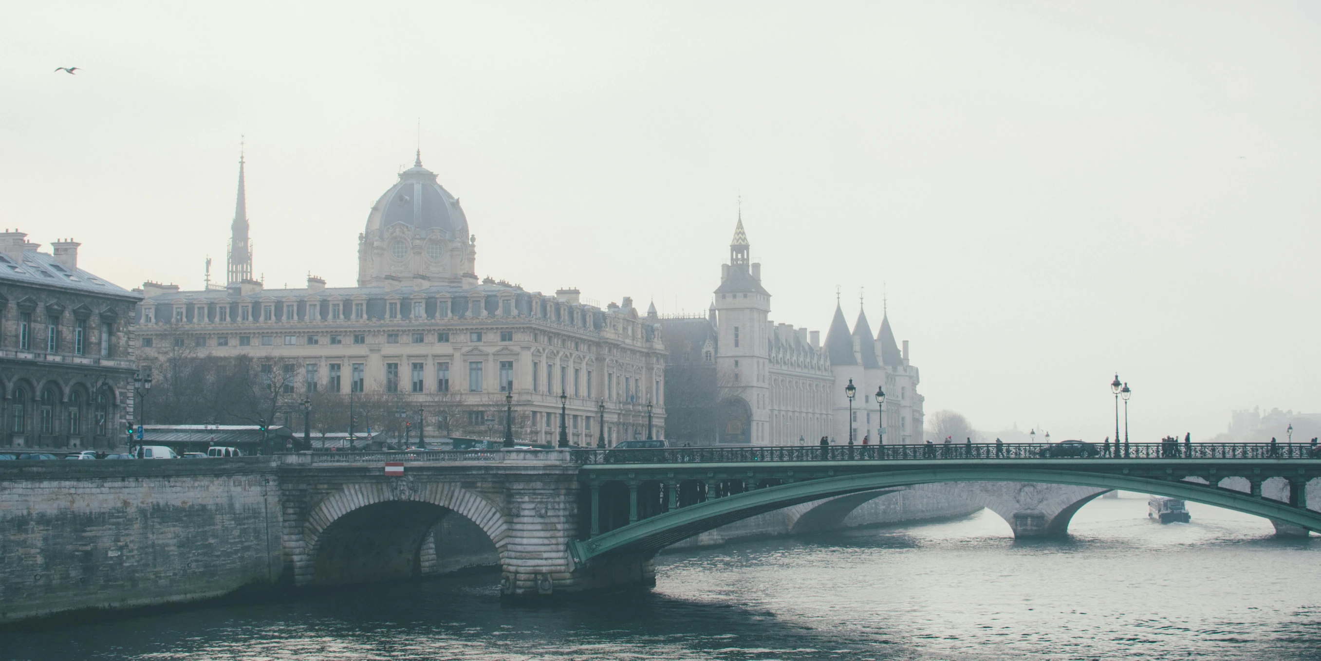 a bridge over a river with buildings in the background, a photo, pexels contest winner, paris school, light grey mist, college, neoclassical, lagoon