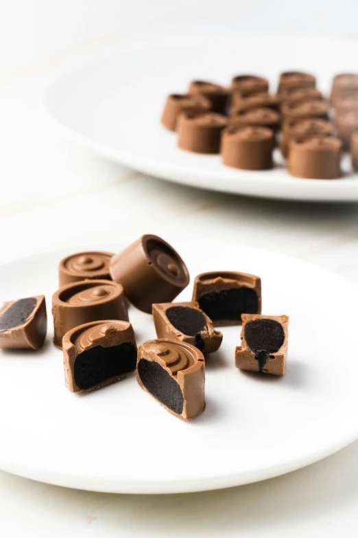 a close up of a plate of chocolates on a table, half turned around, qiangshu, cut-away, 4l