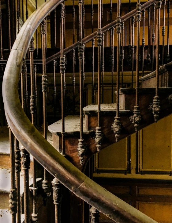 a close up of a spiral staircase in a building, inspired by Francisco Oller, pexels contest winner, art nouveau, rusty pipes, thumbnail, distant photo, looking partly to the left