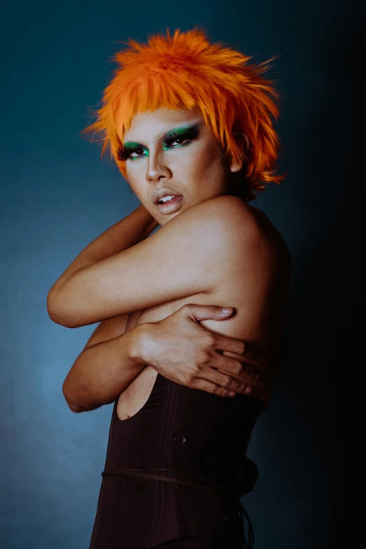 a woman with orange hair posing for a picture, an album cover, inspired by Bert Stern, trending on pexels, malaysian, vixen, queer, 5 th element