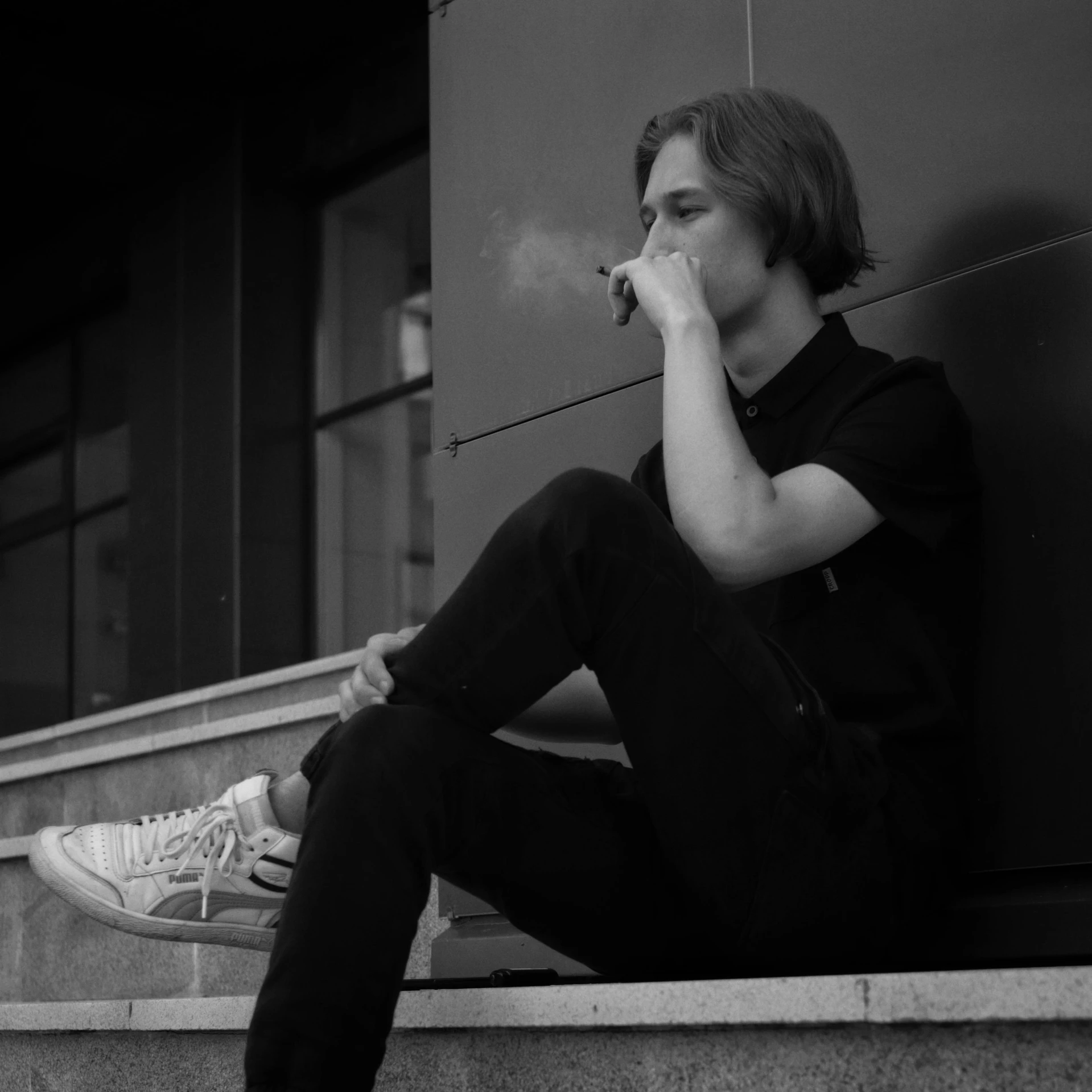 a man sitting on the steps smoking a cigarette, a black and white photo, pexels contest winner, aestheticism, teen boy, dmitry prozorov style, casual pose, high quality upload